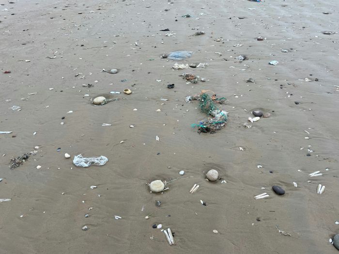 A beach with litter strewn everywhere