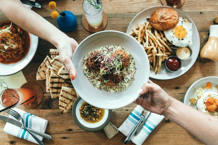 People passing around food at a restaurant.