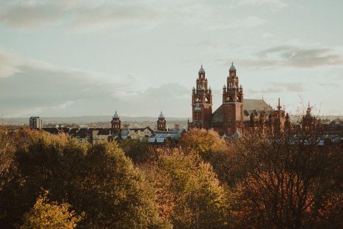 Glasgow city skyline with orange trees in the foreground.