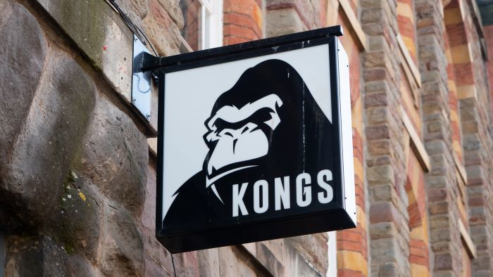 A black and white sign with a gorilla on it saying 'Kongs'