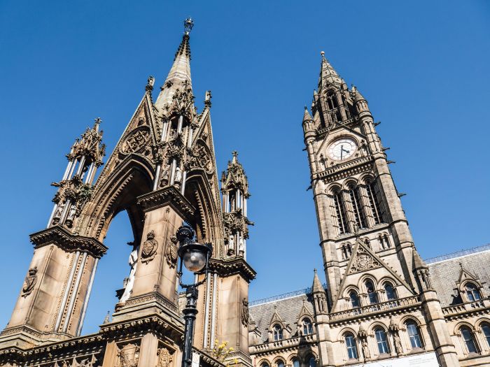 Manchester town hall from below against a blue sky.