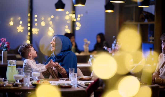 A woman and child playing at a restaurant.