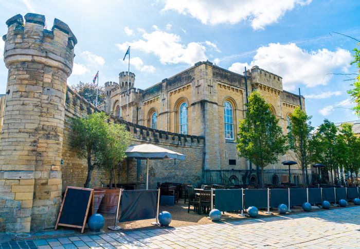 An outdoor seating area at Oxford Castle & Prison on a sunny day.