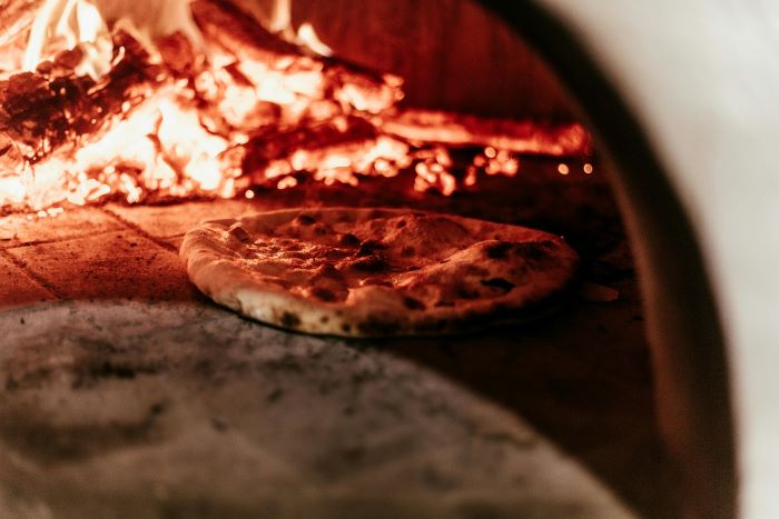 Pizza cooking in a pizza oven