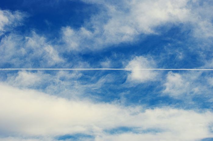 Condensation trail left by plane in the sky