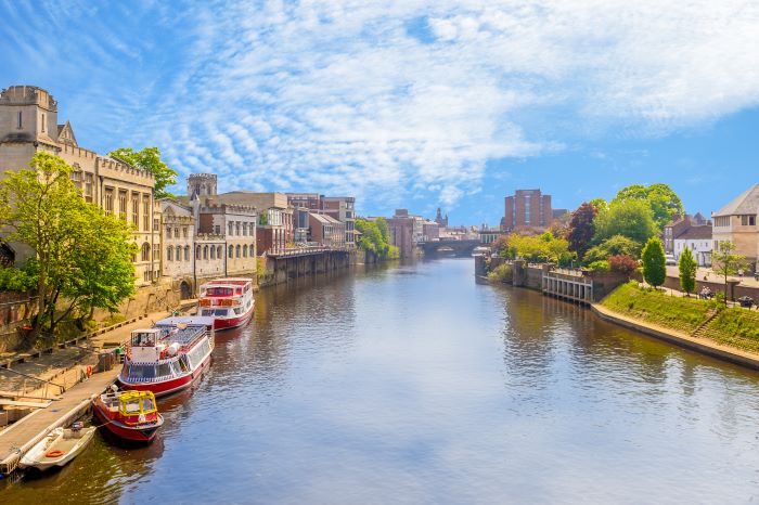 The River Ouse winds through York city centre with historic buildings lining the water.