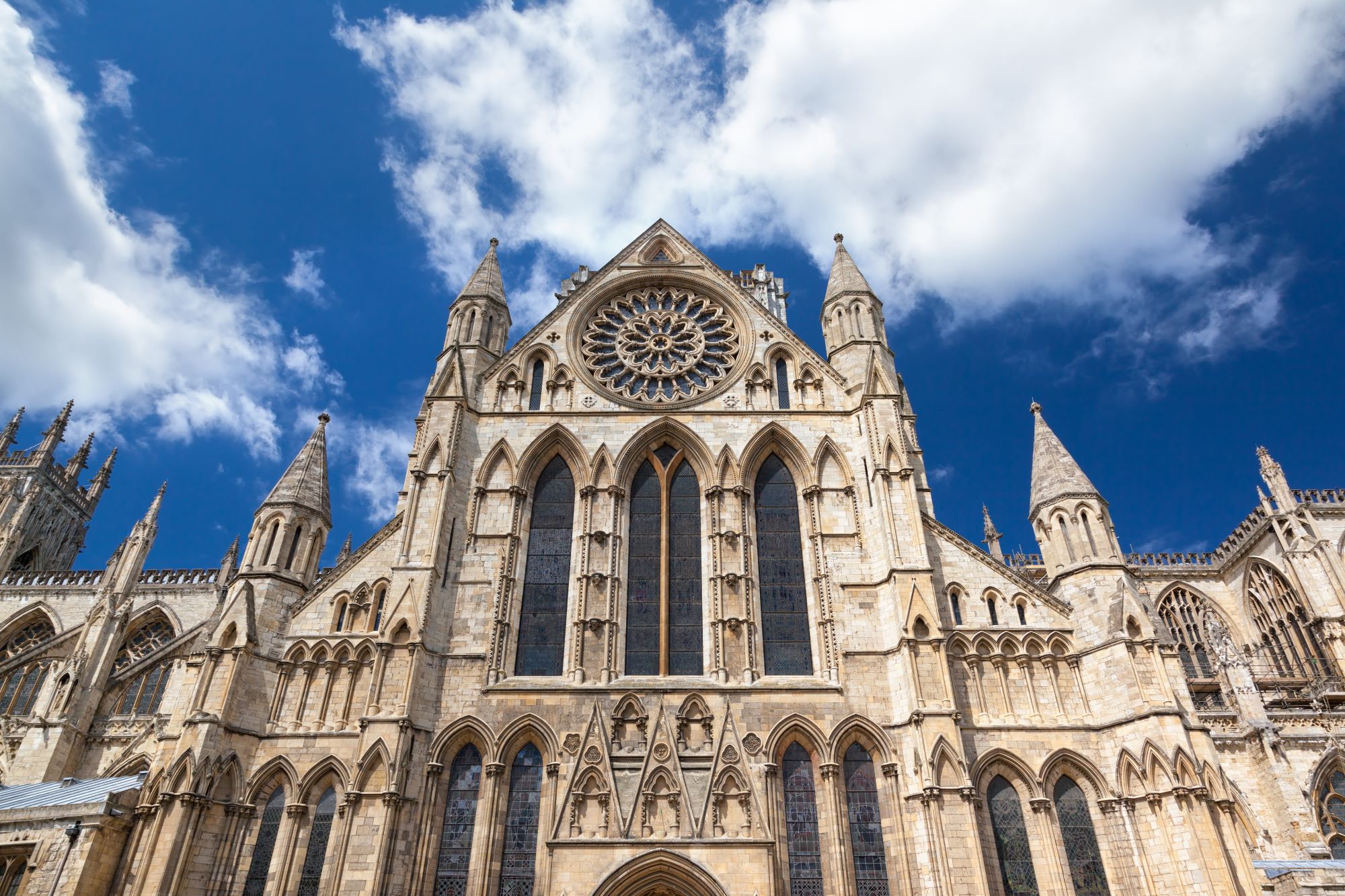 The Gothic architecture of York Minster stands proud against a blue sky.